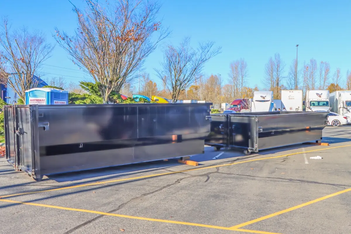 Professional dumpster rental service with roll-off container on residential driveway in Depew